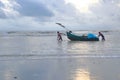 A Fishing Boat Trying to Move Forward at Sea Beach