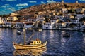 Fishing boat and village in a Greek island Royalty Free Stock Photo