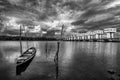 Fishing boat and water barrier and river with cloud sky storm, Black and white and monochrome style Royalty Free Stock Photo