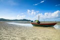 Fishing boat on wavy sand beach