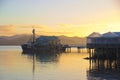 Fishing boat at wharf, fish shop, sunrise, Mangonui, New Zealand Royalty Free Stock Photo