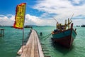 Fishing boat by a wooden bridge with a chinese flag in Tan Jetty, Clan Jetties, Georgetown, Penang, Malaysia