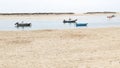 Fishing boats anchored off a beach in an estuary in Benodet