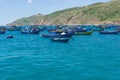 Fishing boats are anchored at the pier in the morning on the blue seawater at Quy Nhon, Vietnam June 2022