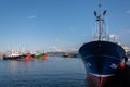 Fishing boats belayed at the harbor after a labor day. Colorful traditional boats used in the Basque country. La Rhune mountain