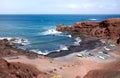 Fishing boats on a black volcanic beach of Lanzarote, Canary Islands, Spain