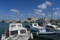 Fishing boats with blue and white wooden hulls in Greek port of Heraklion near the city center during summer. Royalty Free Stock Photo