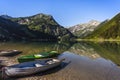 Fishing boats at clear mountain Lake Vilsalpsee with mountain range in the background, Tannheimer Valley, Tyrol, Austria Royalty Free Stock Photo