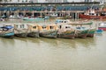 Fishing boats at commercial fish market harbour with skyline bac Royalty Free Stock Photo