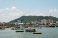 Fishing boats at commercial fish market harbour with skyline bac Royalty Free Stock Photo