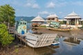 Fishing boats and ferry moored on the coast in Fishing Village