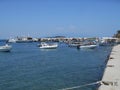 Fishing boats floating on sea near sea dock in Olympiada