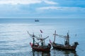 Fishing boats floating in the sea over cloudy sky at Prachuap Khiri Khan, Thailand. Royalty Free Stock Photo