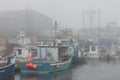 Fishing boats in foggy harbor of Saint Bride`s