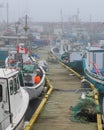 Fishing boats in foggy harbor of Saint Bride`s