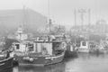 Fishing boats in foggy harbor of Saint Bride`s