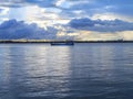 Fishing boats on the Ganges river of India along with blue and cloudy sky