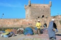 Fishing boats, gear and fishermen on background of Castelo Real of Mogador. Royalty Free Stock Photo