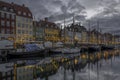 Fishing boats among glittering Christmas decorations in Copenhagen Nyhavn Canal
