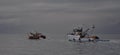 Fishing boats going out to sea. Croatian commercial fishing boat heading out to sea on a cloudy day