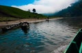 Fishing boats grounded along the Shangu river on a winter morning in Banfladesh. Foggy landscape from another boat Royalty Free Stock Photo