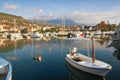 Fishing boats in harbor. Marina Kalimanj in Tivat town on a sunny autumn day with Lovcen mountain in background. Montenegro Royalty Free Stock Photo
