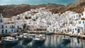 fishing boats in a harbor in a traditional greek island village with old white houses Royalty Free Stock Photo