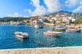 Fishing boats in Kokkari bay with colourful houses in background, Samos island, Greece Royalty Free Stock Photo