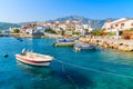 Fishing boats in Kokkari bay with colourful houses in background, Samos island, Greece Royalty Free Stock Photo