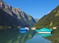 Fishing boats on lake Klontalersee, Switzerland. Glarnisch, mountain rage reflecting in the water. Summer scene. Royalty Free Stock Photo