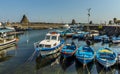 Fishing boats lined up in the harbour of Aci Trezza, Sicily with stacks of Isole dei Ciclopi in the background Royalty Free Stock Photo