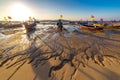 Fishing boats at low tide on the Chalong beach at sunrise time, Phuket, Thailand Royalty Free Stock Photo