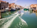 Fishing boats moored in a canal in Chioggia, Italy.