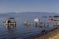 The fishing boats is moored near the shore and wooden, old pier close-up Greece Royalty Free Stock Photo