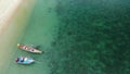 Fishing boats near reef. Beautiful aerial view of fishing boats floating on blue sea water near majestic coral reef. Natural