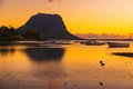 Fishing boats in ocean at sunset time. Le Morn mountain in Mauritius Royalty Free Stock Photo