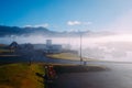 Fishing boats on a pier in blue fog in an early sunny morning in the summer Royalty Free Stock Photo