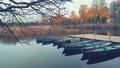 Fishing boats at the pier on the lake in autumn Royalty Free Stock Photo
