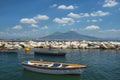 Fishing boats in the port of Naples and view of Mount Vesuvius