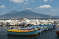 Fishing boats in the port of Naples and view of Mount Vesuvius