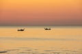 Fishing boats pull their nets at the sunrise. Adriatic cost. Emilia Romagna. Italy Royalty Free Stock Photo