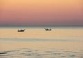 Fishing boats pull their nets at the sunrise. Adriatic cost. Emilia Romagna. Italy Royalty Free Stock Photo