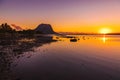 Fishing boats in a quiet ocean at sunset time. Le Morn mountain in Mauritius Royalty Free Stock Photo