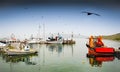 Fishing boats with reflections in an greek small quiet harbor n Royalty Free Stock Photo