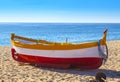 Fishing boats rest on a golden sand beach