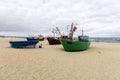 Fishing boats by the sandy beach on the Baltic Sea on a sunny day, Wolin Island, Miedzyzdroje, Poland