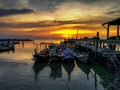 Fishing boats in sea against sky during sunset Royalty Free Stock Photo