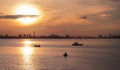 Fishing boats on the sea with city view at sunrise time Royalty Free Stock Photo