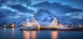 Fishing boats on the sea, snowy rocky mountains, blue sky Royalty Free Stock Photo