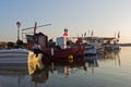 Fishing boats in a small fishing harbour at sunrise in Chalkidiki Royalty Free Stock Photo